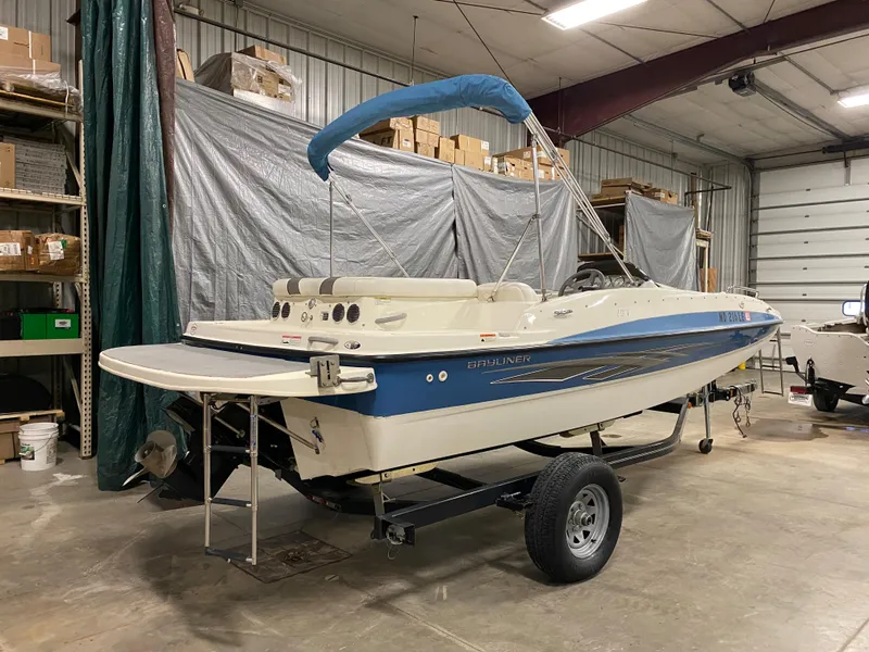 Slide: The Image of 2011 Bayliner 197 boat on trailer in indoor storage facility. - 3