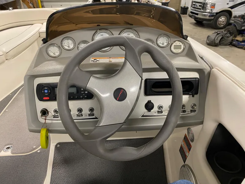 Slide: The Image of 2011 Bayliner 197 boat dashboard with steering wheel and control panel. - 8