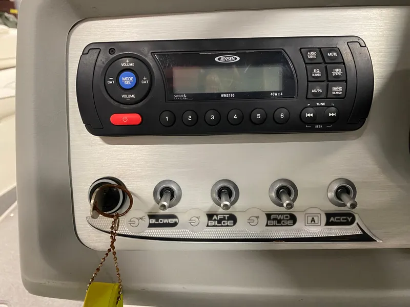 Slide: The Image of Control panel of a 2011 Bayliner 197 boat with radio and switches. - 9