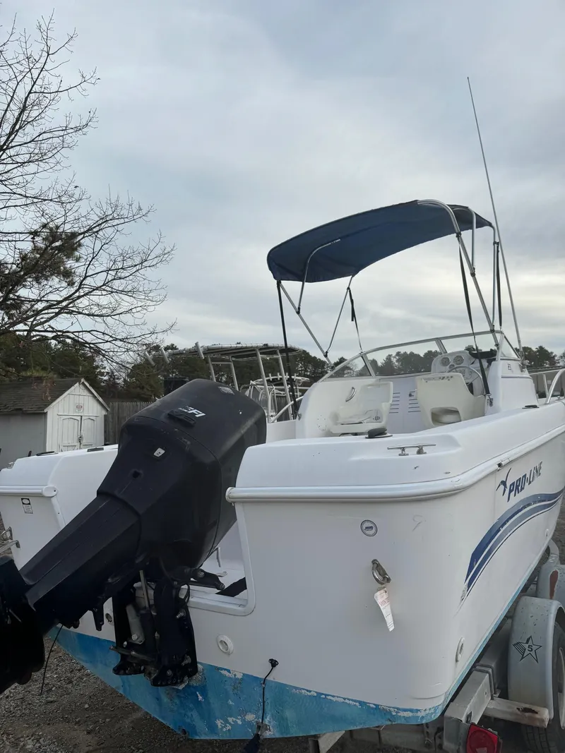 Slide: The Image of 2006 Pro-Line 23 Walk boat with outboard motor and canopy. - 21