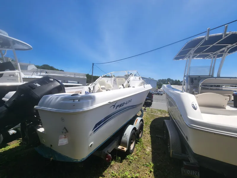 Slide: The Image of 2006 Pro-Line 23 Walk boat on trailer, parked outdoors. - 8