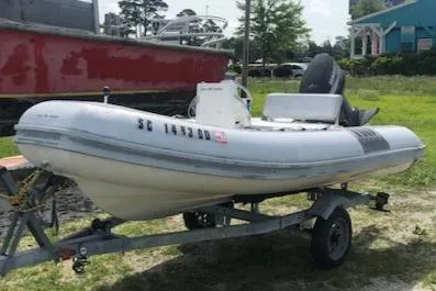The Image of 1995 Novurania Tender boat on trailer, parked outdoors. - 1