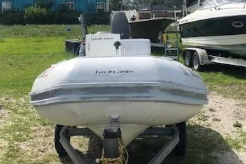 Slide: The Image of 1995 Novurania Tender boat on trailer, parked on grassy area. - 3