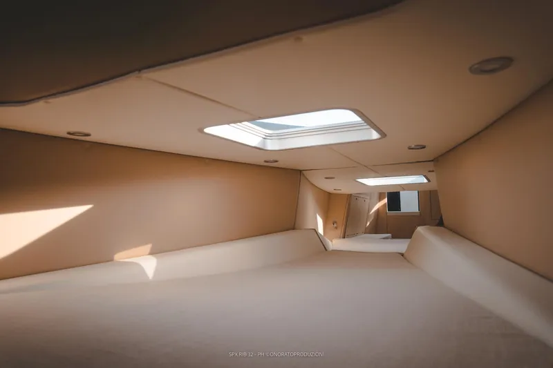 Slide: The Image of Interior cabin of 2025 SPX RIB 32 Dinette with skylight and modern design. - 25