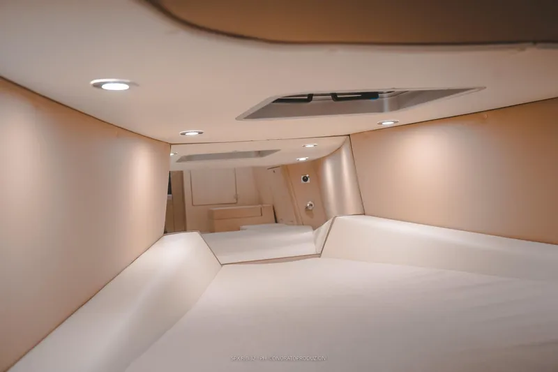 Slide: The Image of Interior cabin of 2025 SPX RIB 32 Dinette, featuring modern lighting and sleek design. - 27
