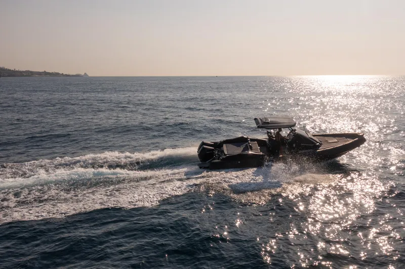 Slide: The Image of 2025 SPX RIB 32 Dinette cruising on the ocean at sunset. - 3