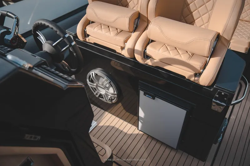 Slide: The Image of Interior of 2025 SPX RIB 32 Sport boat with luxury seating and modern controls. - 31