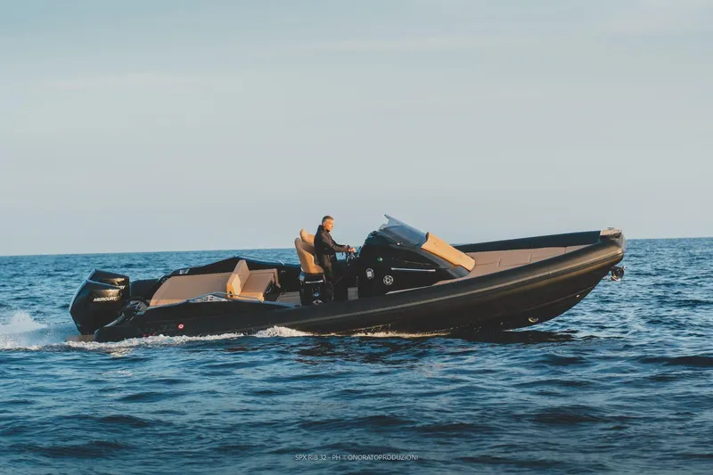 Slide: The Image of 2025 SPX RIB 32 Sport cruising on open water. - 4
