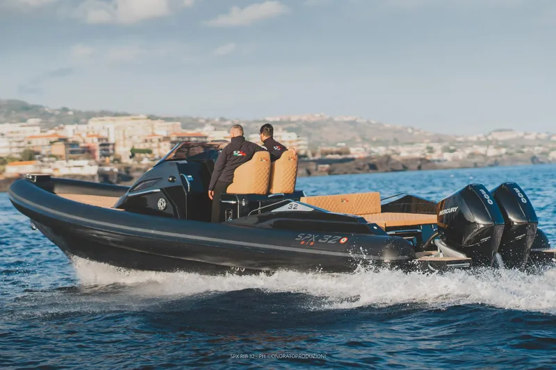 Slide: The Image of 2025 SPX RIB 32 Dinette cruising on the water with dual engines. - 8