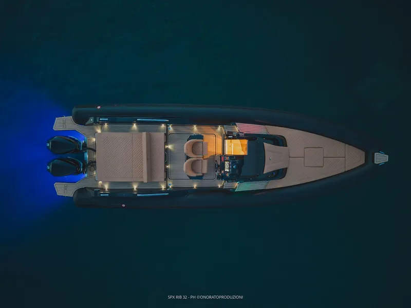 Slide: The Image of Top view of 2025 SPX RIB 32 Sport boat with illuminated deck. - 9