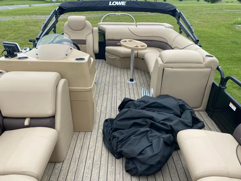 Slide: The Image of 2020 Lowe SS 190 Pontoon boat with beige seating and black cover on deck. - 6