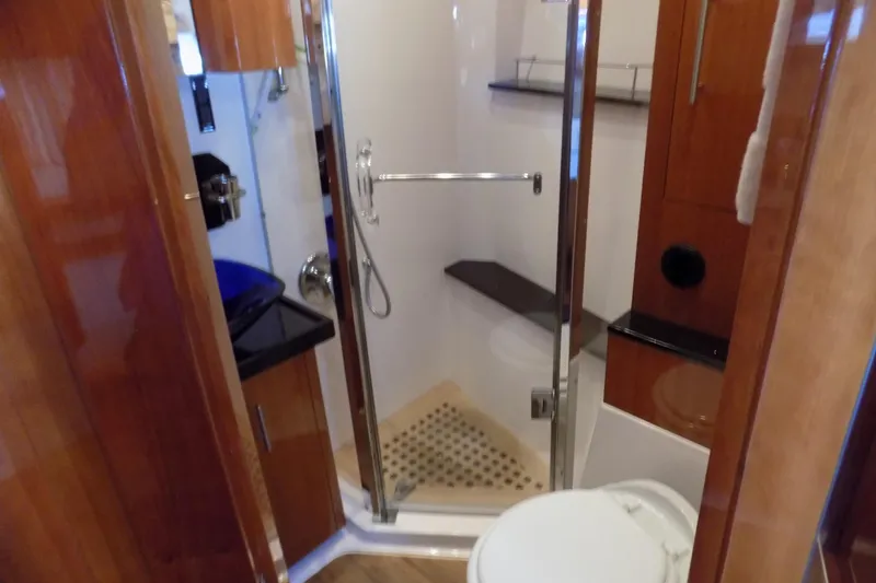 Slide: The Image of Luxurious bathroom in 2012 Regal 52 Sport Coupe yacht with modern fixtures and wood accents. - 12
