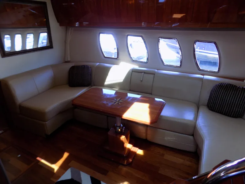 Slide: The Image of Luxurious interior of 2012 Regal 52 Sport Coupe with leather seating and wooden table. - 13