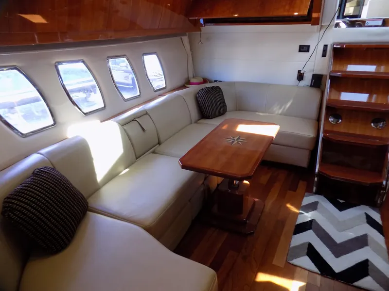 Slide: The Image of Luxurious interior of 2012 Regal 52 Sport Coupe yacht with plush seating and wooden accents. - 15