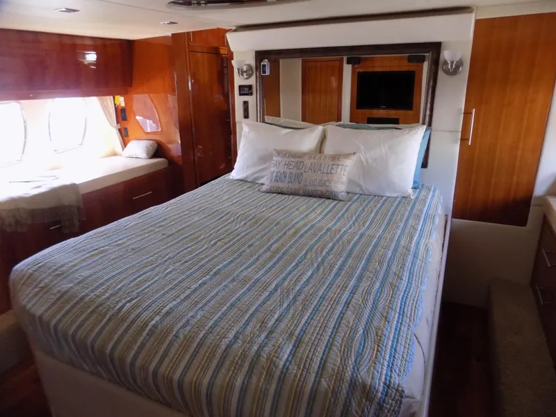 Slide: The Image of Luxurious bedroom interior of 2012 Regal 52 Sport Coupe yacht with striped bedding. - 9