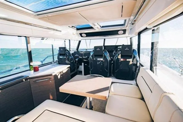 Slide: The Image of Luxurious interior of 2024 Wellcraft 355 boat with modern seating and panoramic windows. - 3