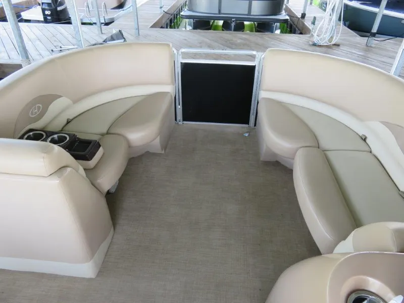 Slide: The Image of 2016 Harris FloteBote Cruisers CX200 interior with beige seating and cup holders. - 2
