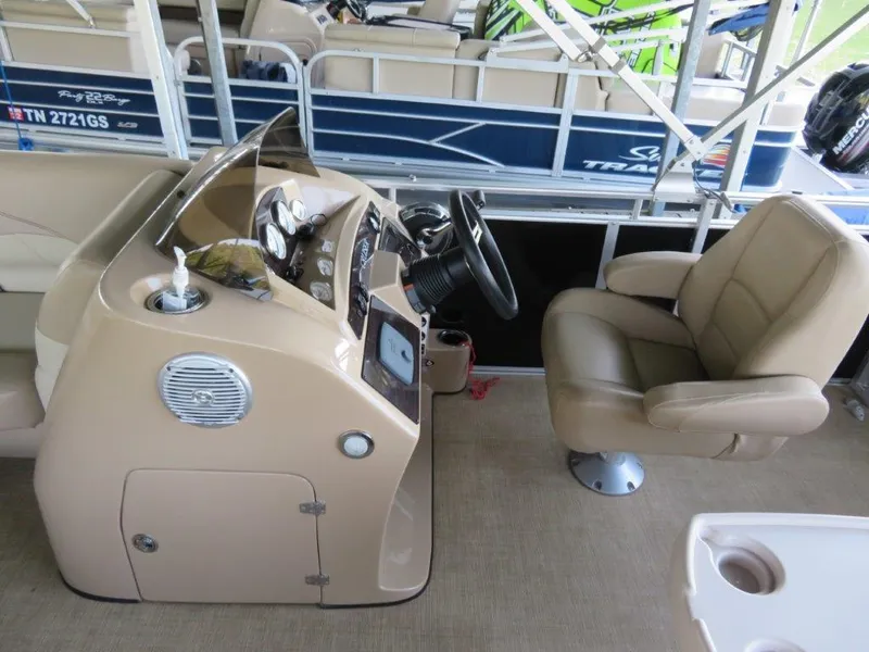 Slide: The Image of 2016 Harris FloteBote Cruisers CX200 helm with beige captain's chair and control panel. - 4