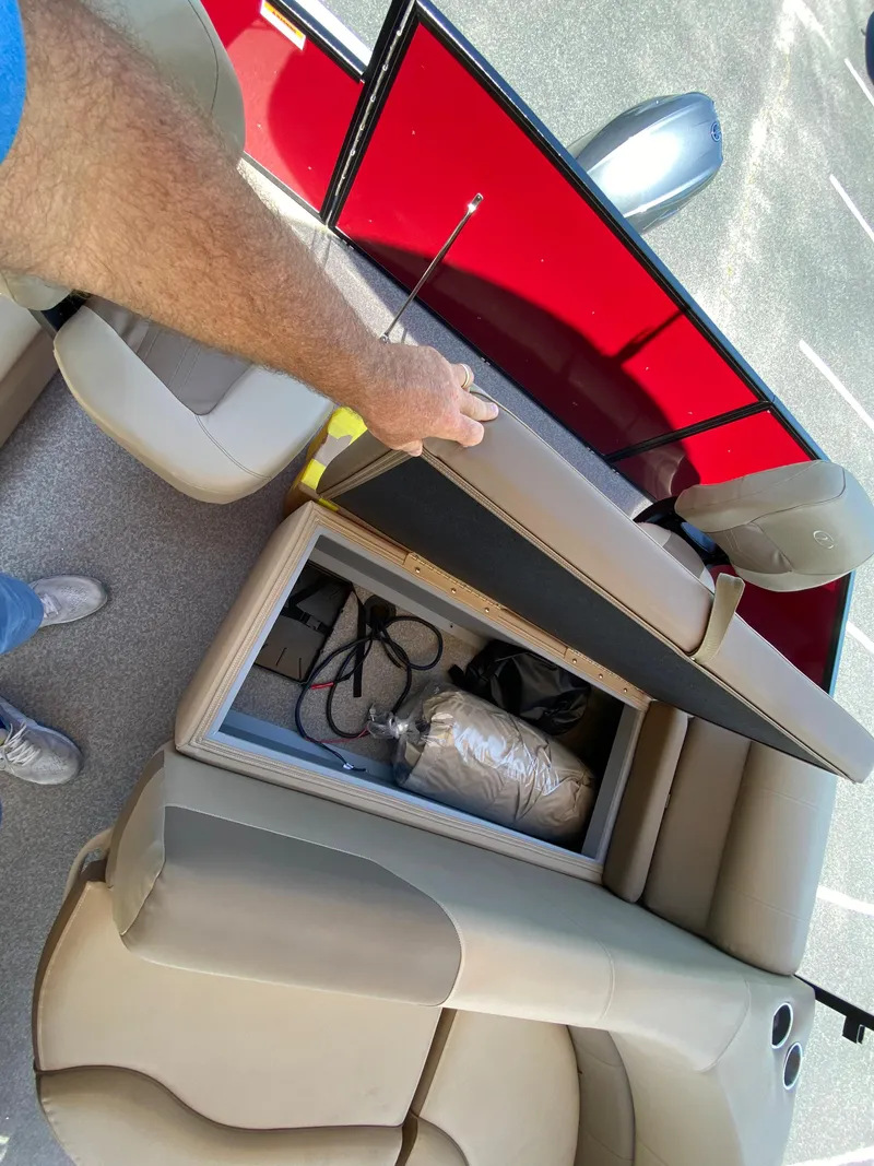 Slide: The Image of 2023 Veranda Fish VF20F4 boat interior storage compartment with beige seating. - 13