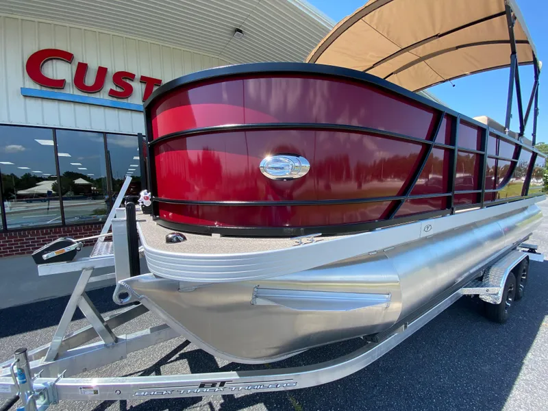Slide: The Image of 2023 Veranda Fish VF20F4 pontoon boat with red exterior on a trailer. - 19