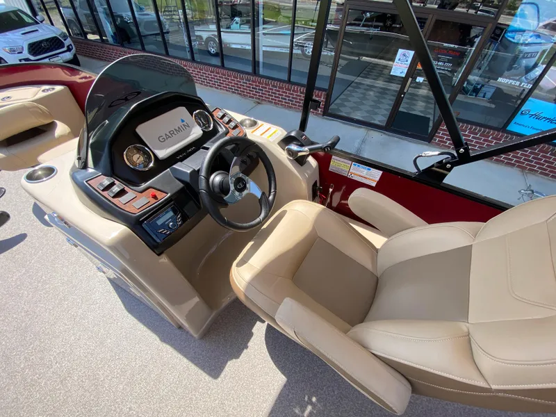 Slide: The Image of 2023 Veranda Fish VF20F4 boat interior with Garmin navigation system and beige seating. - 9