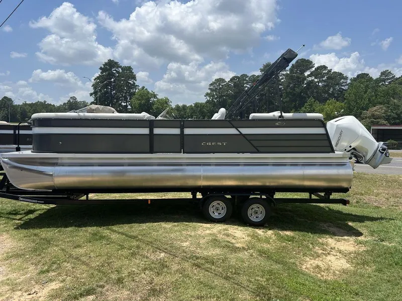 Slide: The Image of 2022 Crest Classic DLX 240 SLSC pontoon boat on a trailer. - 1