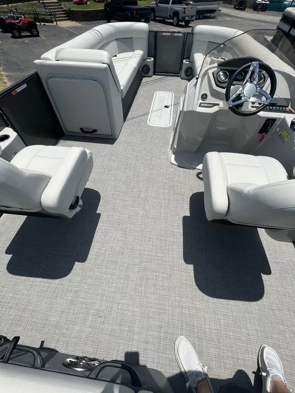 Slide: The Image of 2022 Crest Classic DLX 240 SLSC pontoon boat interior with white seating and steering console. - 13