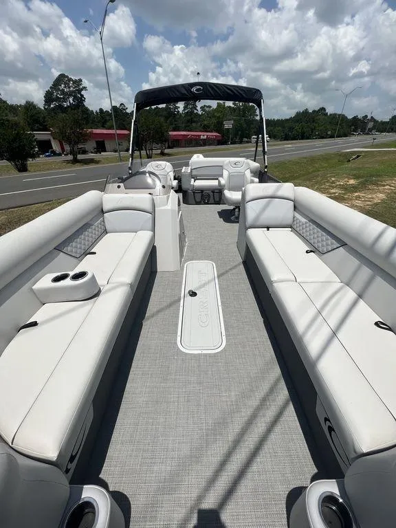 Slide: The Image of 2022 Crest Classic DLX 240 SLSC pontoon boat with spacious seating and modern design. - 2