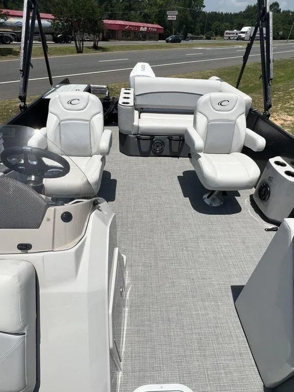 Slide: The Image of 2022 Crest Classic DLX 240 SLSC pontoon boat interior with plush seating and modern design. - 6