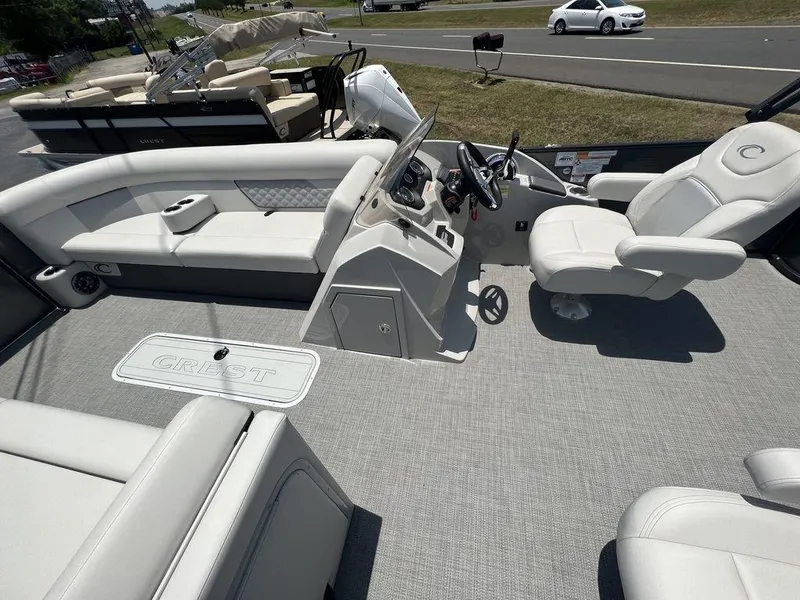 Slide: The Image of 2022 Crest Classic DLX 240 SLSC boat interior with white seating and steering console. - 8