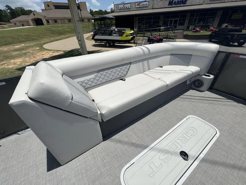 Slide: The Image of 2022 Crest Classic DLX 240 SLSC boat with spacious white seating area. - 9