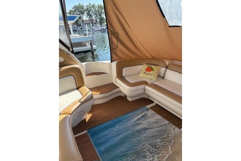 Slide: The Image of Interior of 2000 Sea Ray Sundancer boat with cozy seating and nautical decor. - 46
