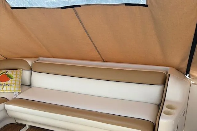 Slide: The Image of 2000 Sea Ray Sundancer interior with beige and white seating, canopy, and decorative pillow. - 47