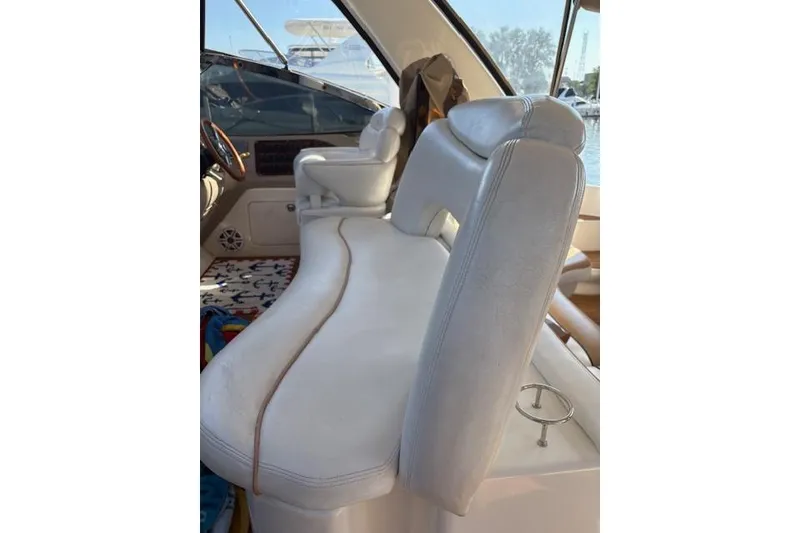 Slide: The Image of Interior of 2000 Sea Ray Sundancer boat with white seating and steering area. - 51