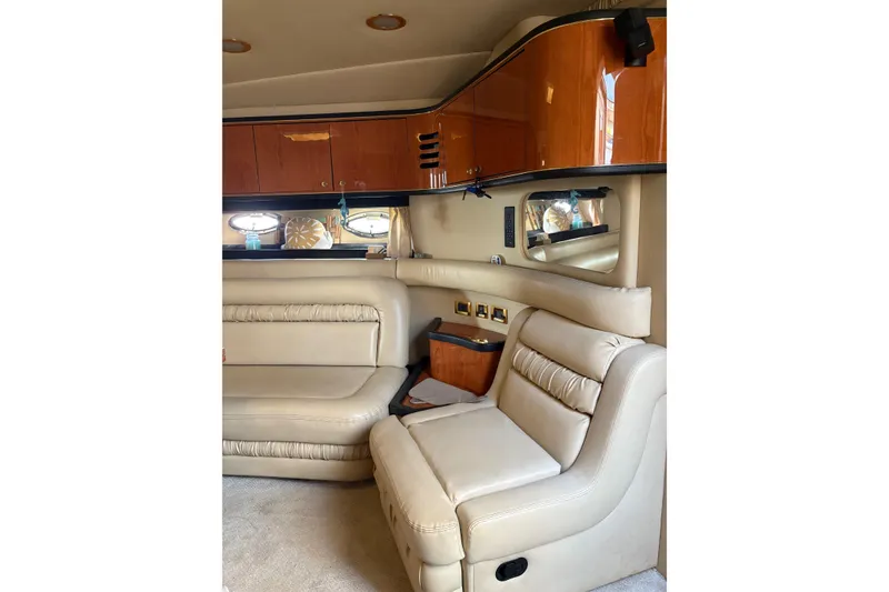 Slide: The Image of Interior of 2000 Sea Ray 460 Sundancer yacht with beige leather seating and wooden cabinets. - 53