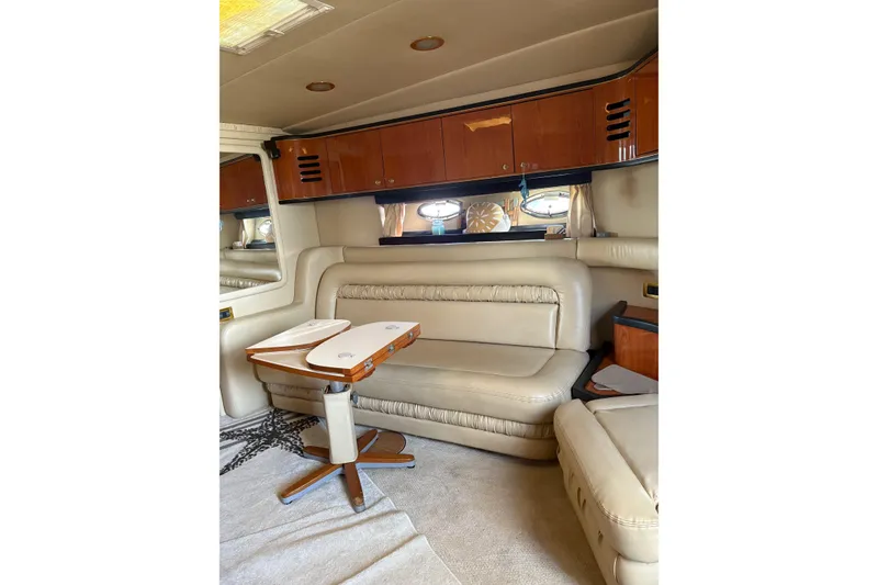 Slide: The Image of Luxurious interior of 2000 Sea Ray 460 Sundancer yacht with leather seating and wooden cabinetry. - 54