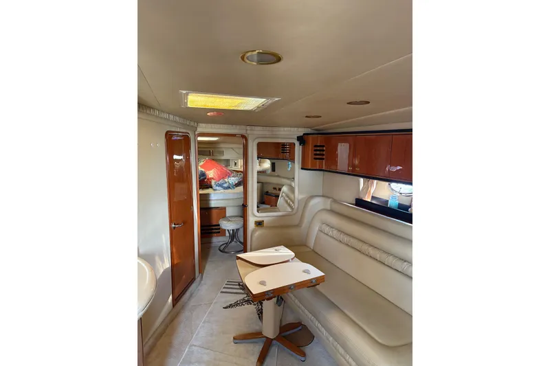 Slide: The Image of Interior of 2000 Sea Ray 460 Sundancer yacht with seating and wooden cabinetry. - 58
