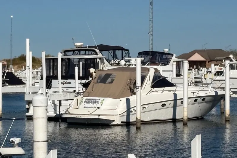 Slide: The Image of 2000 Sea Ray 460 Sundancer yacht docked at marina, surrounded by other boats. - 61