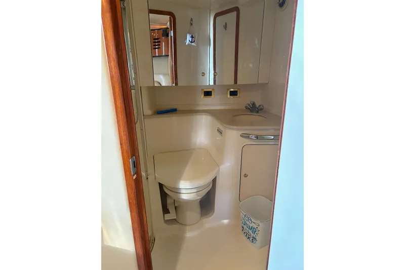Slide: The Image of Bathroom interior of 2000 Sea Ray 460 Sundancer yacht, featuring toilet and sink. - 62