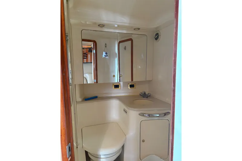 Slide: The Image of Bathroom interior of 2000 Sea Ray 460 Sundancer yacht, featuring sink and mirror. - 63