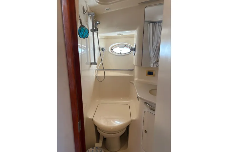 Slide: The Image of Bathroom interior of 2000 Sea Ray 460 Sundancer yacht, featuring shower and toilet. - 66