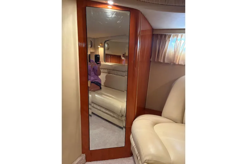 Slide: The Image of Interior of 2000 Sea Ray 460 Sundancer with mirror and beige seating. - 68