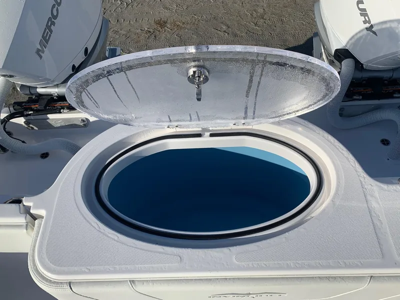 Slide: The Image of Open hatch on 2024 Invincible 33 Catamaran with Mercury engines in background. - 12