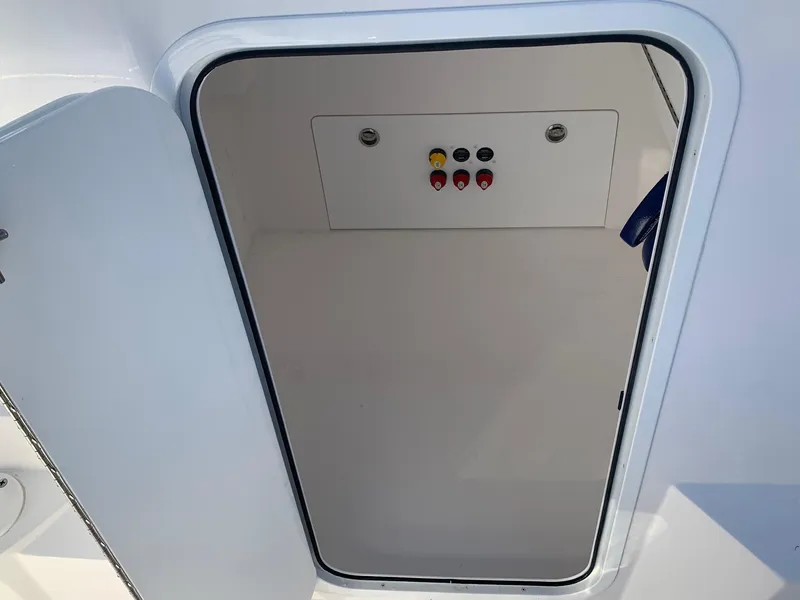 Slide: The Image of 2024 Invincible 33 Catamaran storage compartment with control panel. - 13