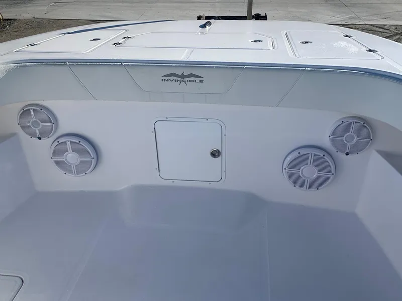 Slide: The Image of 2024 Invincible 33 Catamaran boat interior with speakers and storage compartment. - 16