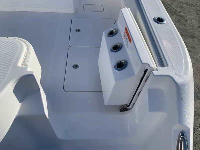 Slide: The Image of 2024 Invincible 33 Catamaran deck with rod holders and storage compartments. - 6