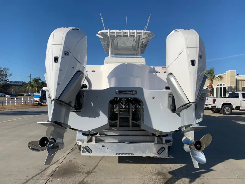 Slide: The Image of 2024 Invincible 33 Catamaran with twin outboard engines, rear view. - 2