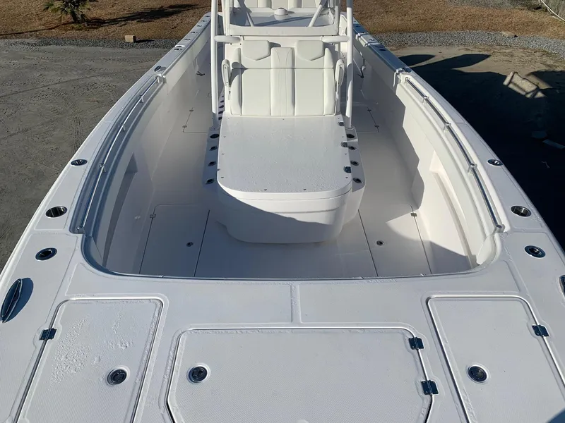 Slide: The Image of 2024 Invincible 33 Catamaran boat interior with spacious seating and storage compartments. - 21