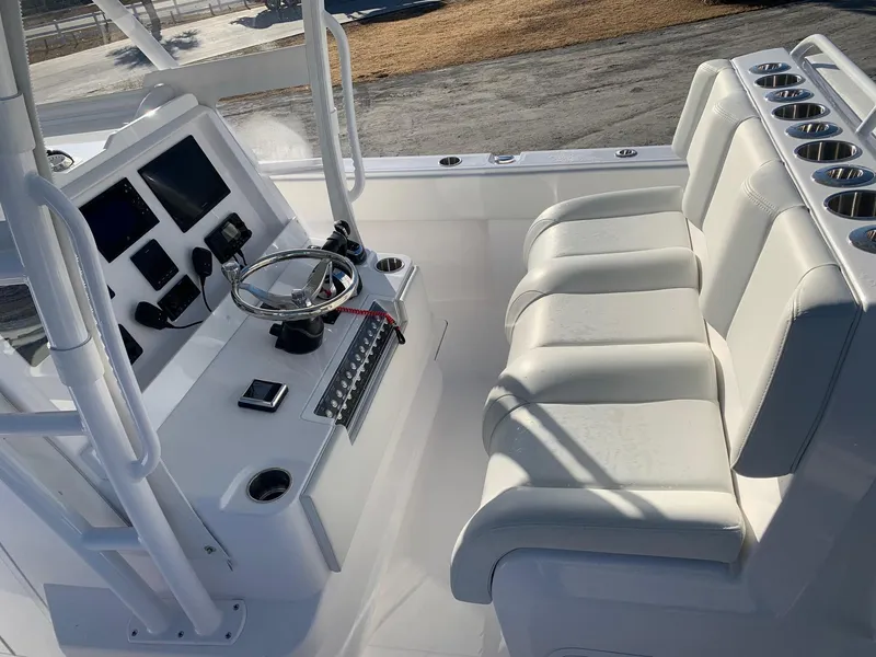 Slide: The Image of 2024 Invincible 33 Catamaran cockpit with white seating and advanced navigation controls. - 5