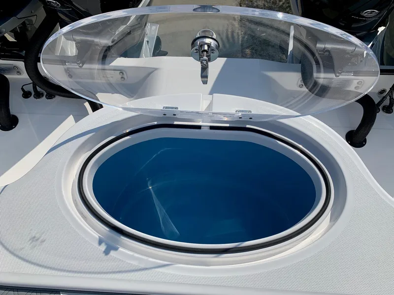 Slide: The Image of 2024 Invincible 35 Catamaran livewell with open lid and blue interior. - 10